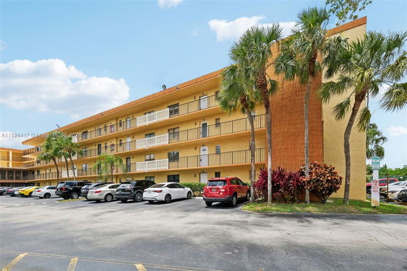 Front view of a multi-story apartment building with balconies.