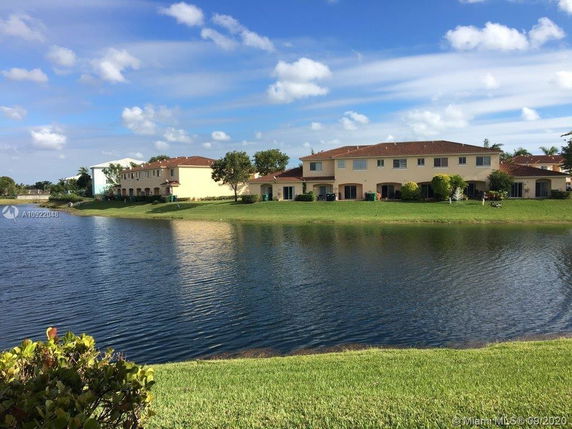 View of several two-story houses by a waterfront.