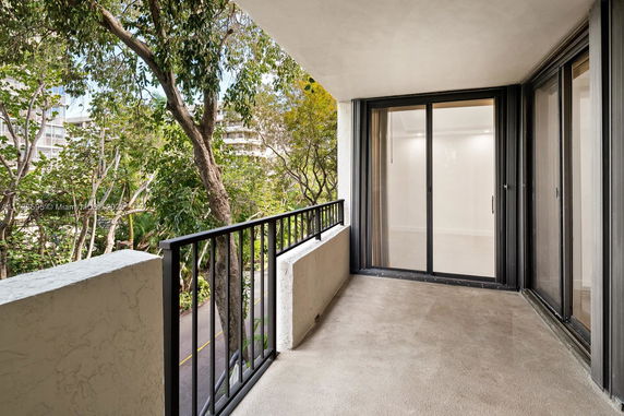 Balcony view with trees and buildings in the background