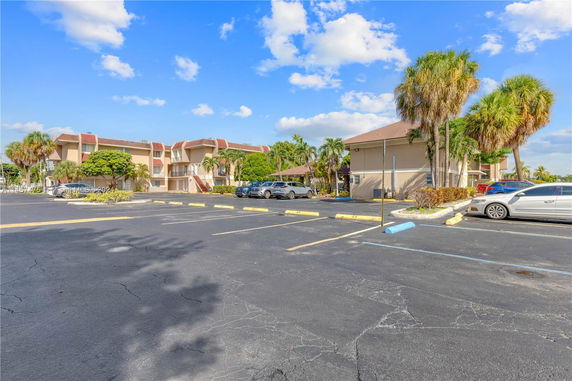 Outdoor parking area in front of a multi-story building.