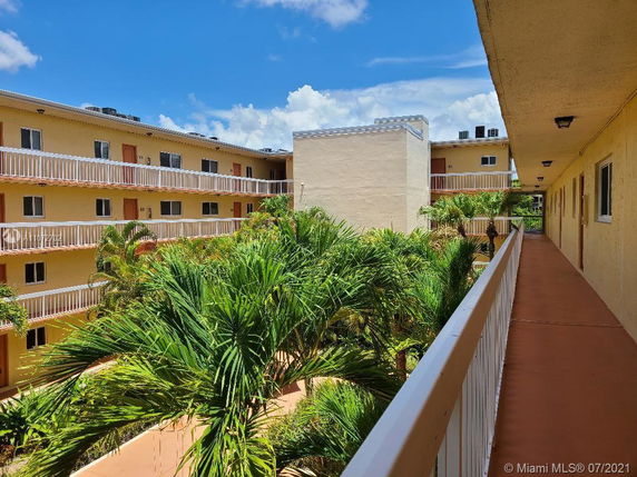 View of a multi-story apartment building with balconies.