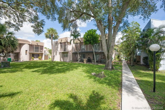 Front view of a two-story apartment building with balconies.