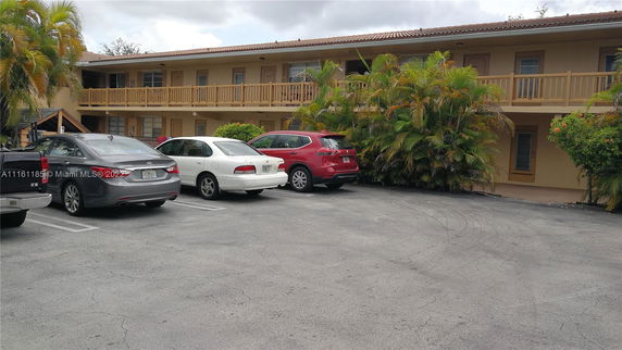 Outdoor parking area adjacent to a two-story building