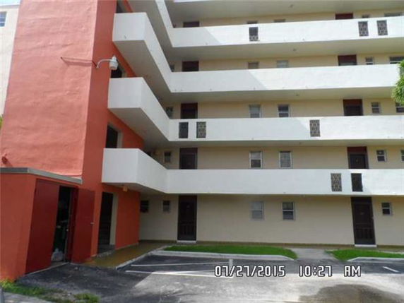 Front view of a multi-story residential building with balconies.