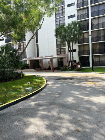 Front view of a multi-story residential building with balconies.