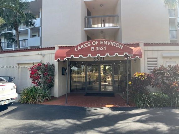 Front view of a building entrance with a red awning labeled 'Lakes of Environ B 3521'.
