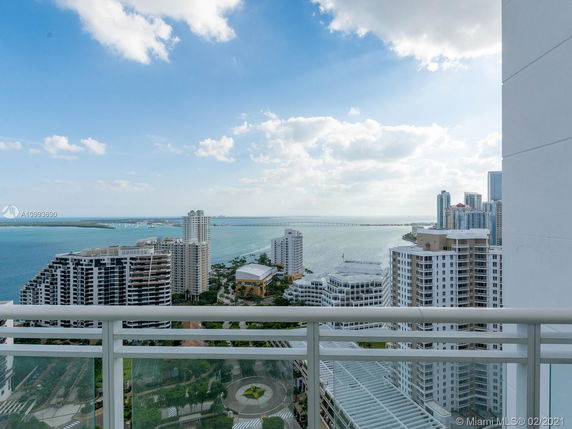 Panoramic view showcasing high-rise buildings and a body of water.