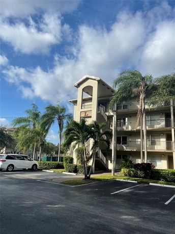 Front view of a multi-story building with an exterior staircase.