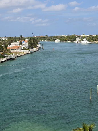 Wide angle view of a river with houses and yachts along the shoreline.