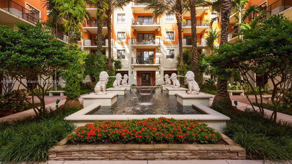 Central courtyard of a multi-story building with balconies and a fountain featuring lion statues.