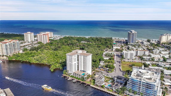 Aerial view of coastal buildings and ocean in the background.