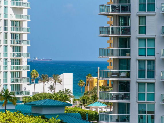 Panoramic view of the ocean and surrounding buildings from a high-rise