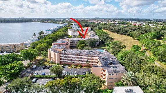 Panoramic view highlighting a cluster of multi-story buildings near a body of water.