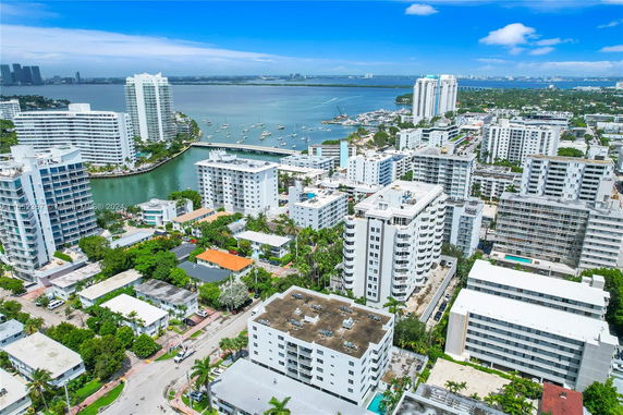 Aerial view of a coastal city with multiple residential buildings and waterways.