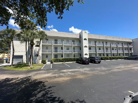 Front view of a multi-story residential building with balconies.