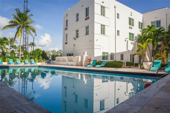 View of a multi-story building with an outdoor swimming pool in the foreground.
