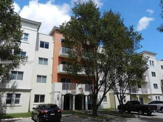 Front view of a multi-story residential building with balconies.