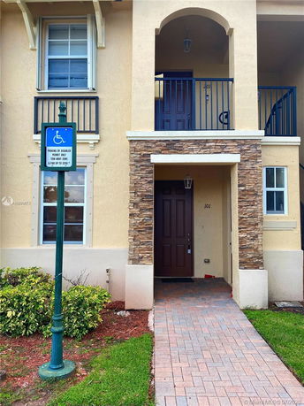 Front view of a two-story house with a stone accent column.