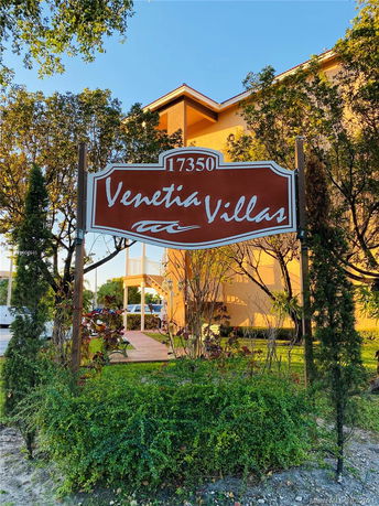 Front view of a multi-story building with a sign reading 'Venetia Villas'.