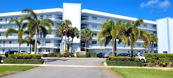 Front view of a multi-story residential building with balconies.