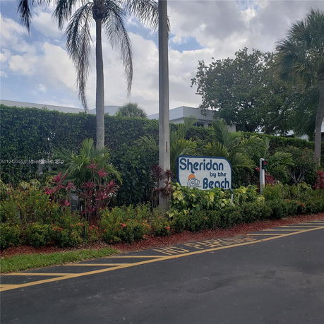 Front view of a building with a sign reading 'Sheridan by the Beach'.