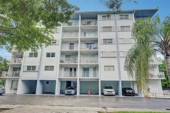 Front view of a multi-story residential building with balconies.