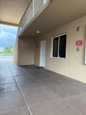 Exterior view of a building entrance with a covered walkway.
