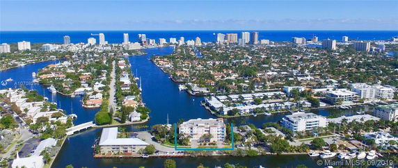 Panoramic view of a cityscape with waterways and high-rise buildings in the background.