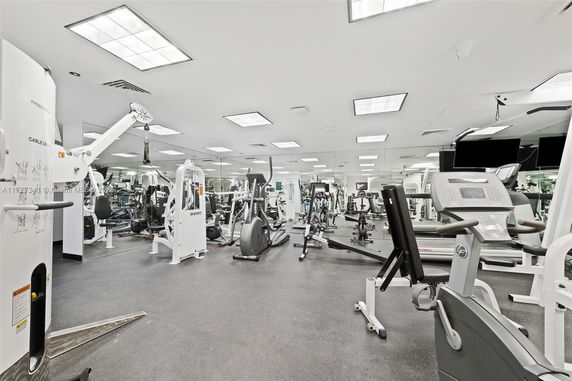 Indoor gym area with various exercise equipment.
