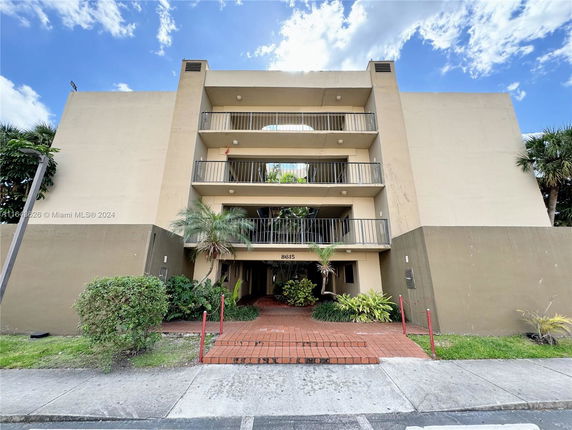 Front view of a multi-story building with balconies.
