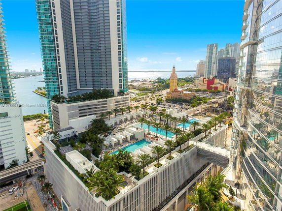 View of modern high-rise buildings and cityscape with surrounding areas visible from above.