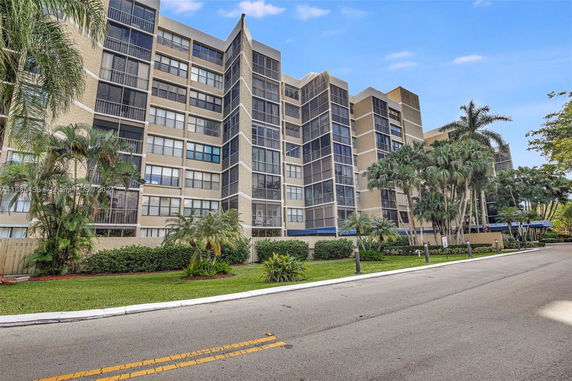 Front view of a multi-story residential building with balconies.