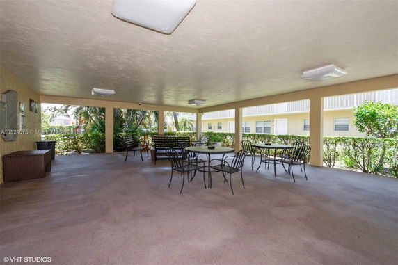 Covered area with seating and tables in a communal setting.