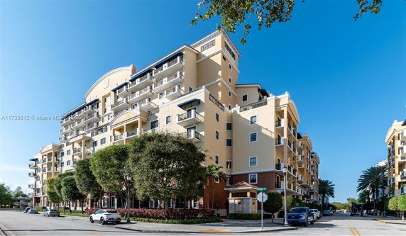 Front view of a multi-story apartment building with balconies.