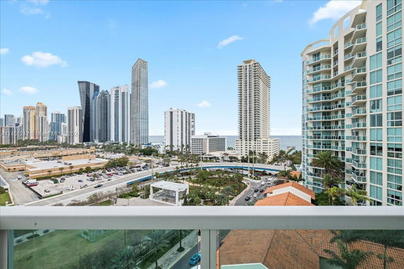 Panoramic view of a cityscape with multiple high-rise buildings near the coastline.