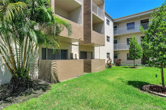 Front view of a multi-story apartment building with balconies.