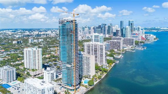 Panoramic view of tall buildings and water body in a cityscape.