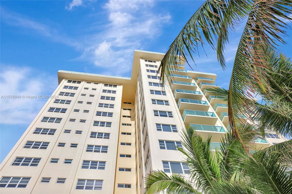 Front view of a high-rise apartment building with balconies.
