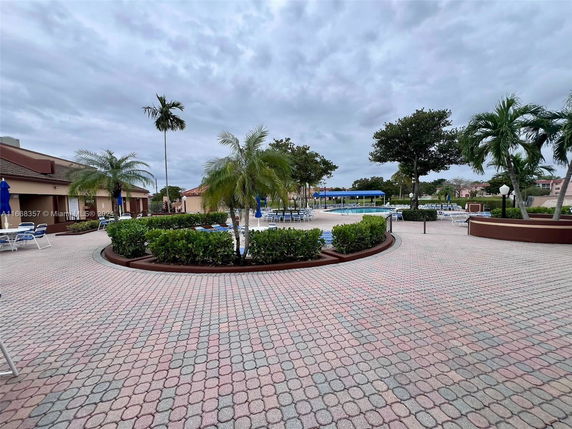 Outdoor area with a swimming pool and surrounding patio seating.