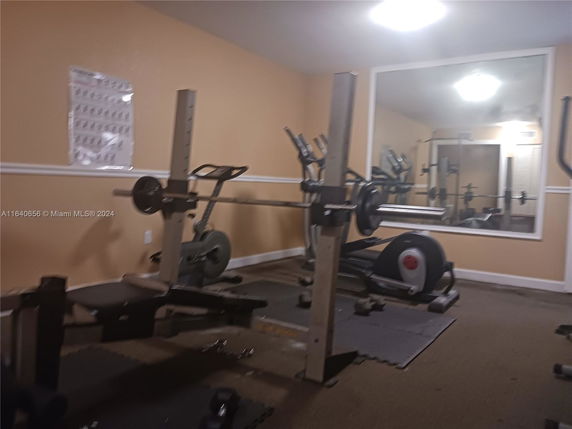 Indoor gym area with exercise equipment and mirrors.