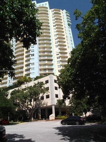 Front view of a multi-story residential building with balconies.