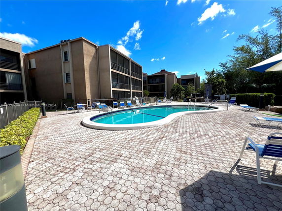 Outdoor area featuring a swimming pool surrounded by buildings.
