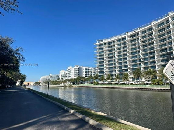 View of a series of modern apartment buildings along a waterfront.