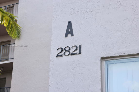 Exterior view of a building with a visible section showing the letter 'A' and number '2821'.