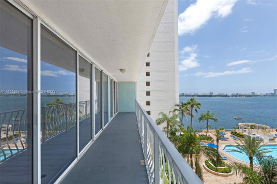 Balcony view showing a body of water and distant cityscape.