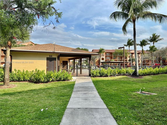 Front view of a small building with a sloped roof and a gated entrance.