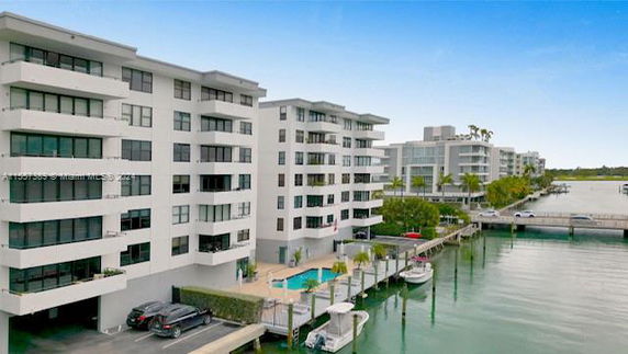 View of a waterfront multi-story residential building with a dock.