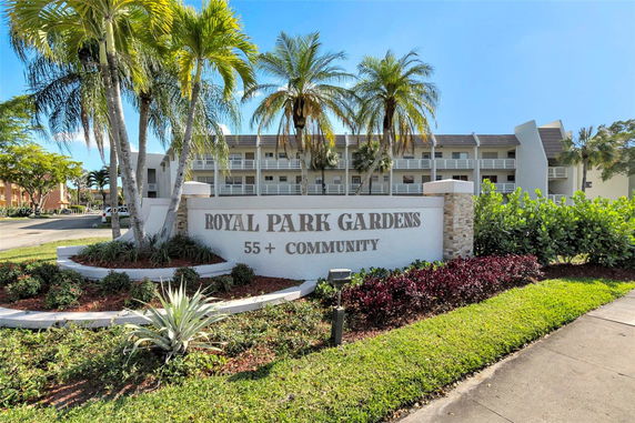 Front view of a multi-story building with a sign indicating 'Royal Park Gardens 55+ Community'.