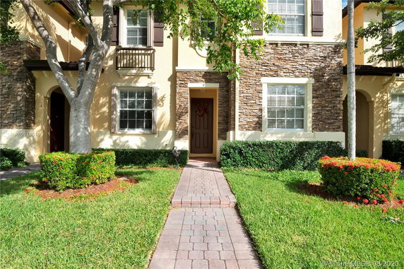 Front view of a two-story house with stone and stucco exterior.