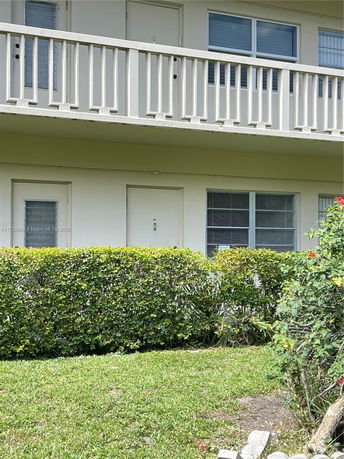 Front view of a two-story building with balconies.
